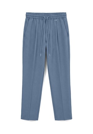 Blaue, zulaufende Sweatpants mit elastischem Bund, Kordelzug, Seitentaschen und einem kleinen Metallring neben der rechten Tasche.