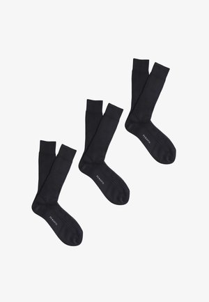 Tre paia di calzini neri a coste, lunghezza media, con il nome del marchio "PEROFIL" stampato vicino alle dita, su sfondo bianco.