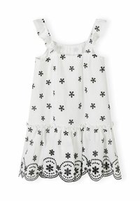 Robe blanche sans manches avec broderie florale noire, bretelles volantes et jupe à volants avec des détails en bordure festonnée. Tissu doux et texturé.