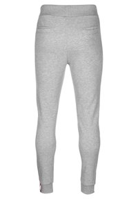 Graue Jogginghose mit tailliertem Schnitt, aus weichem Stoff gefertigt. Zu den Merkmalen gehören Seitentaschen und gerippte Bündchen an den Knöcheln.