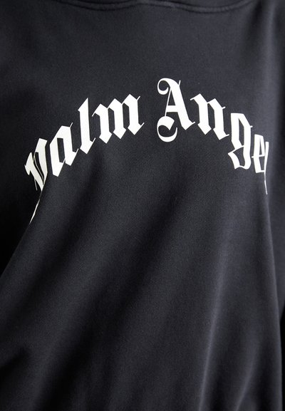 Black sweatshirt featuring white Gothic-style text "Palm Angels" in an arched design across the chest, made of soft cotton fabric.