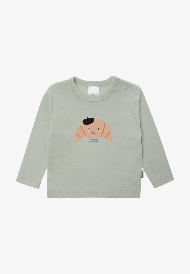 Langärmliges, mintgrünes Hemd aus weichem Baumwollstoff. Mit einem Croissant-Graphic mit einem lächelnden Gesicht und schwarzem Barett sowie einem Etikett am Kragen.