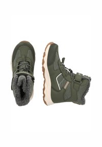 Groene outdoor laarzen met een gestructureerde bovenkant, zachte voering van bont en rubberen zool. Voorzien van een verstelbare band en een gevoerd kraag voor comfort.