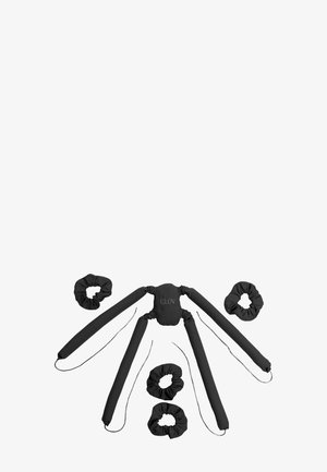 Bâtons à boucler les cheveux en tissu noir et chouchous assortis disposés sur un fond blanc, étiquetés « GLOV » sur la pièce centrale.
