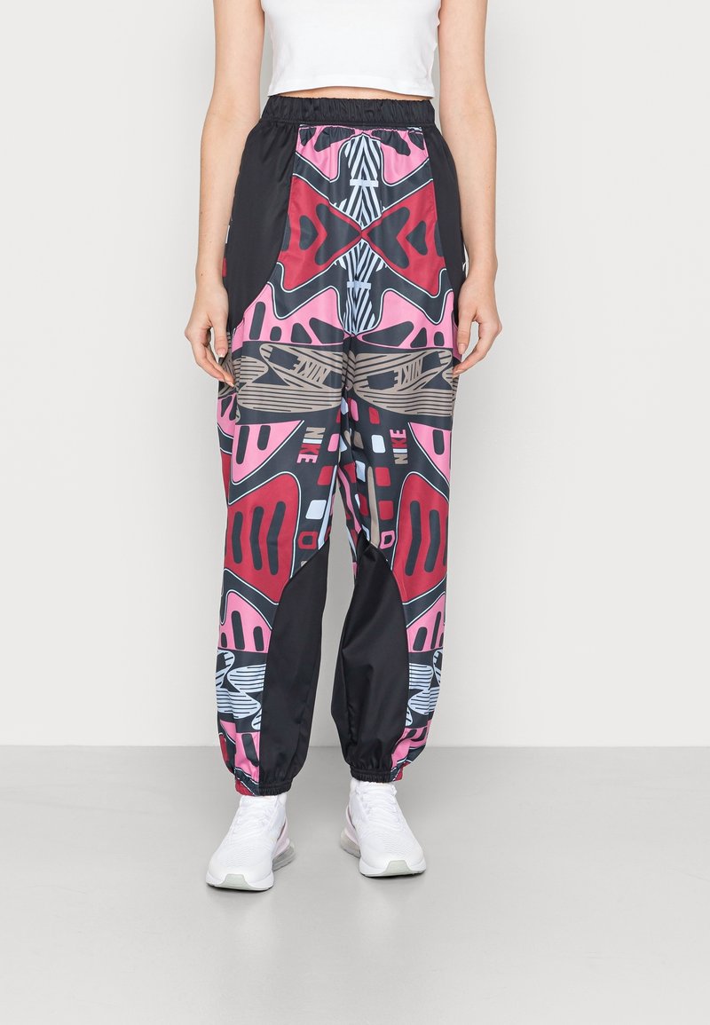 Colorful patterned joggers with a blend of black, pink, red, and gray. Features an elastic waistband and cuffed ankles.