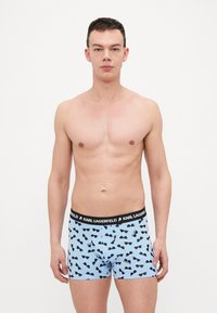 Pantofole leggere azzurre con motivo di occhiali da sole neri, elastico in vita nero con marchio "KARL LAGERFELD", materiale in cotone, design aderente.