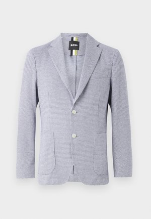 Hondstooth-gepatenteerde blazer in blauw en wit. Kenmerkt zich door een notch-lapel, twee knopen en voorzakken. Gemaakt van gestructureerde stof.