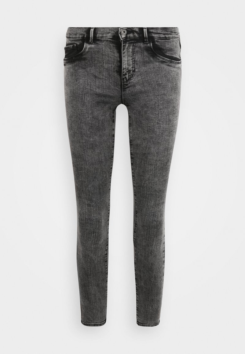 Jeans ajustados en un lavado negro desgastado, con un diseño clásico de cinco bolsillos, cremallera y cierre de botón metálico con ligera textura.