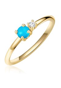 Anello d'oro con una pietra preziosa turchese rotonda e un piccolo accento di diamante, montato su griffe, con una fascia liscia e lucida.