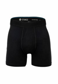 Black boxer brief made of soft fabric, featuring an elastic waistband with “STANCE” branding, and a structured front pouch for support.