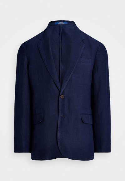 Μπλε λινό σακάκι με κλείσιμο ενός κουμπιού, δύο μπροστινές τσέπες, κοψίματα πέτου και ετικέτα στον γιακά. Λείο υλικό και κομψή εφαρμογή.