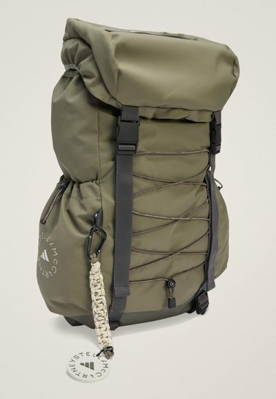 Olive green backpack with roll-top design, multiple straps, a side pocket, and a decorative cord with a loop. Features a logo detail.