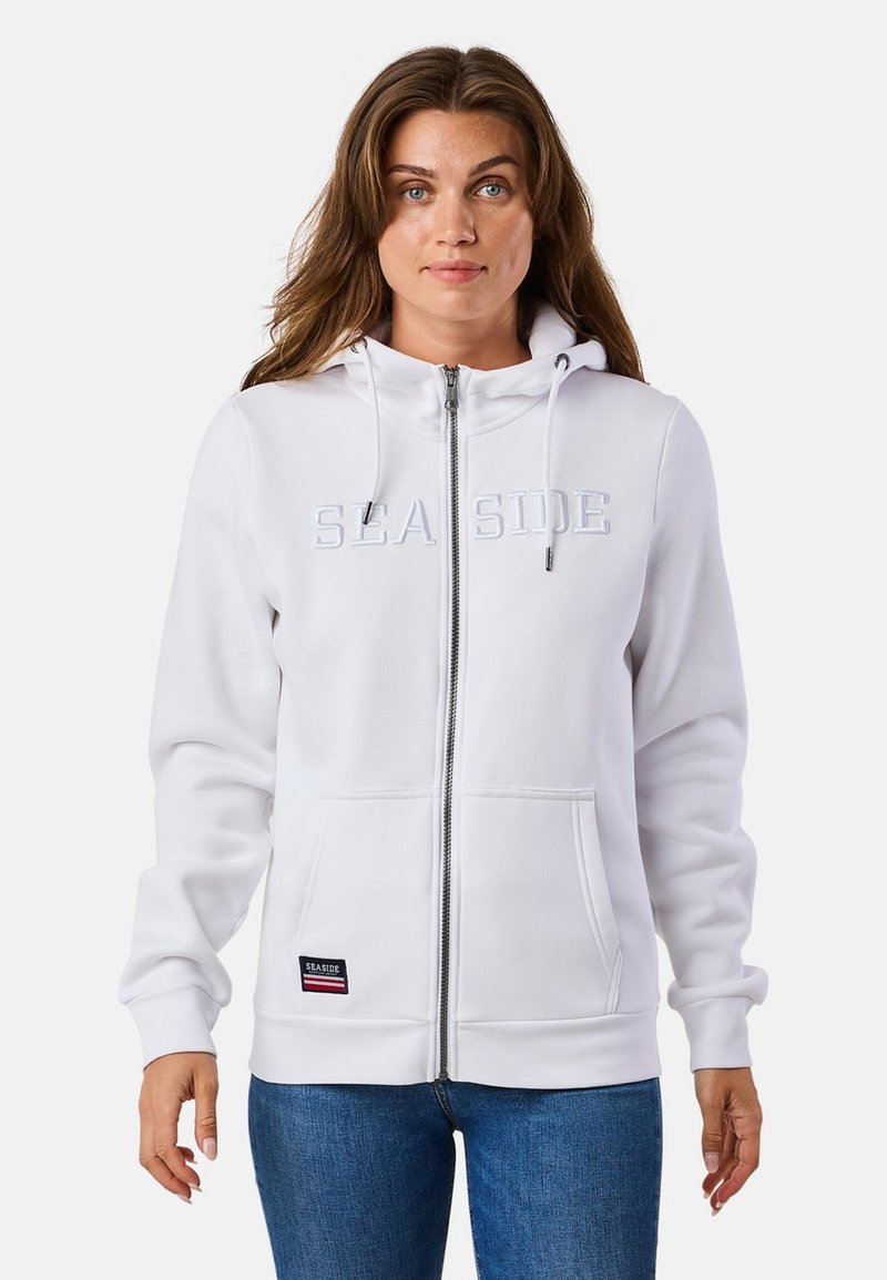 Weißer Reißverschluss-Hoodie mit "SEA SIDE" Aufschrift, Kordelzügen, Taschen vorne und gerippten Bündchen. Der Stoff ist glatt und bietet lässigen Komfort.