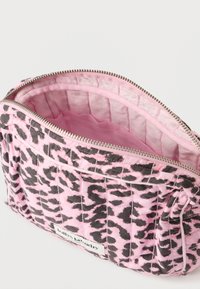Roza denarnica s potiskom leopardjega vzorca, izdelana iz mehke tkanine z vzorcem prešitega blaga. Ima zadrgo za zapiranje in gladilo svetlo roza notranjo podlogo.