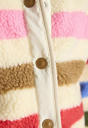 Close-up of multicolored sherpa fleece jacket with pink, brown, cream, and red stripes and branded brown snap buttons on cream placket.