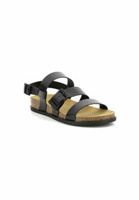 Sanda negra de cuero con diseño de tres correas, hebilla ajustable, plantilla de corcho y suela de goma texturizada.
