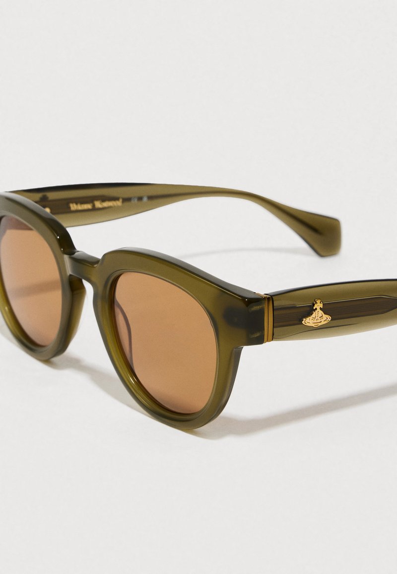 Olive green sunglasses with brown lenses, chunky rounded frames, and gold hardware on temples featuring a distinctive logo.