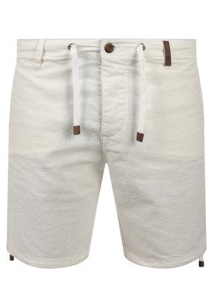 Light beige shorts made of cotton, featuring a drawstring waist, brown accents, and a slightly textured surface. Mid-thigh length design.