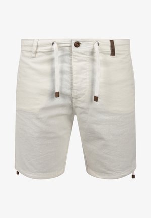 Light beige shorts made of cotton, featuring a drawstring waist, brown accents, and a slightly textured surface. Mid-thigh length design.