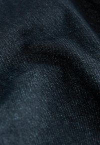 Donkerblauwe denimstof met een subtiele glans, voorzien van een gladde textuur en een consistente weefsel. Geen zichtbare patronen of accenten.