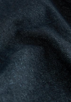 Tissu en denim bleu foncé avec un éclat subtil, présentant une texture lisse et un tissage homogène. Aucun motif ou accent visible.