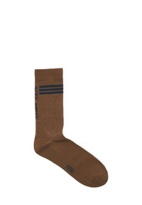 Bruine katoenen sok met een geribde boord, voorzien van twee marineblauwe strepen en de tekst "LUCKY LOOSER" in blauw, samen met het jaar "1990" in marineblauw.