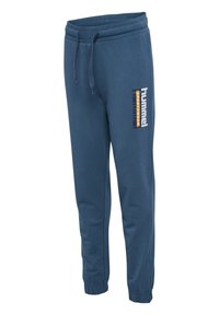 Jogging bleu marine avec taille élastique et poignets, avec le logo « hummel SPORTSWEAR » sur la cuisse gauche.