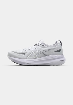 White athletic running shoe with mesh upper, reflective accents, cushioned sole, and a textured, durable outsole for grip.