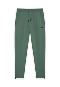 Groene joggingbroek met een trekkoord in de taille, zijzakken en een klein geel logo. Beschikt over ritsen bij de enkels voor gemakkelijk aan- en uittrekken.