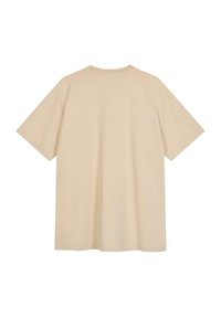 Camiseta de gran tamaño color beige con mangas cortas, cuello redondo y una textura suave y lisa. Sin patrones ni gráficos visibles.