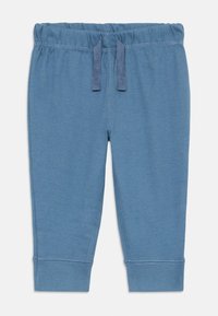 Pantalons en coton stretch bleu avec une taille élastique, un cordon de serrage ajustable et des poignets ajustés. Texture lisse, design décontracté.