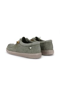 Green canvas shoes with a textured finish, beige rubber sole, and wooden accents. Features a small logo on the heel.