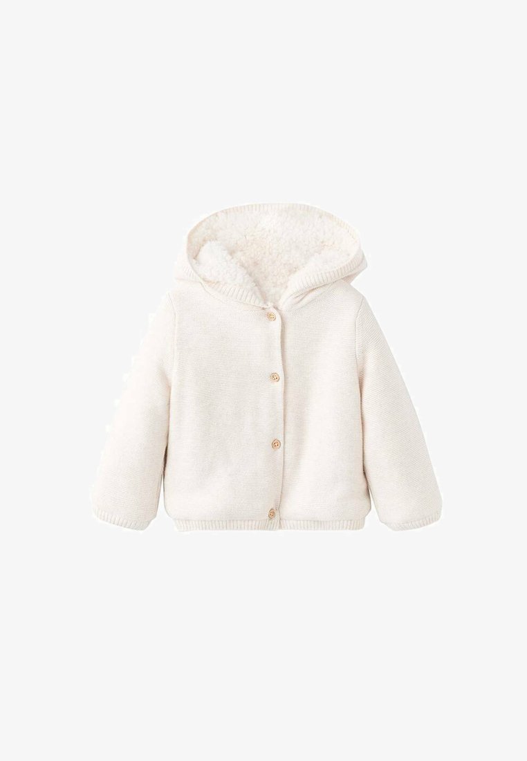Krémová, kapucňová bunda s měkkým, huňatým vnitřkem, žebrovanými manžetami a pěti dřevěnými knoflíky po celé přední části. Pletená textura po celém povrchu.