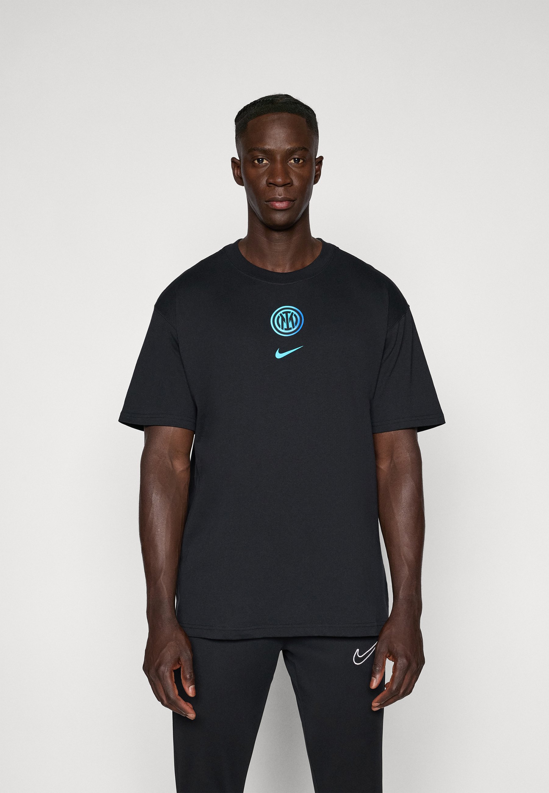 black nike shirt with blue swoosh