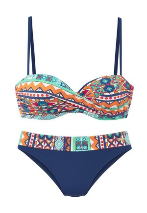 Two-piece bikini with geometric and tribal patterns in orange, teal, navy blue, and white; top has adjustable navy straps and ruched detail.