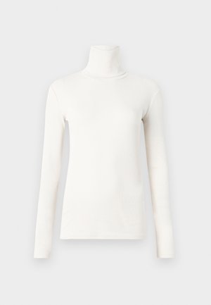 Pika pikhuga turtleneck-särk beežikraanis, mis on valmistatud pehmest ja venivast kangast, millel on ülikitsas disain ja soonikuline tekstuur.