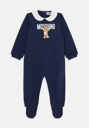 Marineblauer Overall mit langen Ärmeln, weißem Peter-Pan-Kragen, Bärenmotiv und 'Moschino'-Text. Mit Fußteilen und gerippten Bündchen ausgestattet.