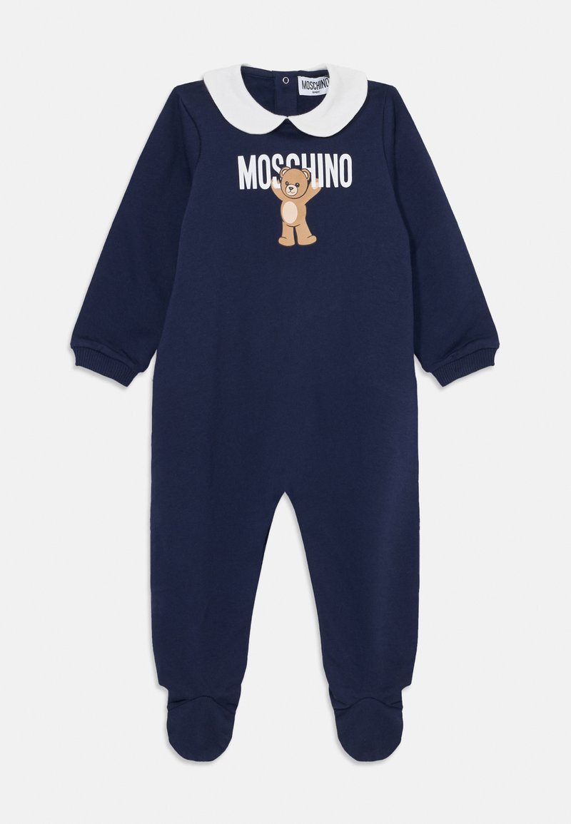 Marineblauer Overall mit langen Ärmeln, weißem Peter-Pan-Kragen, Bärenmotiv und 'Moschino'-Text. Mit Fußteilen und gerippten Bündchen ausgestattet.