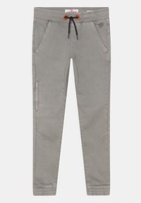 Harmaat slim-fit jumppahousut, joissa on joustava vyötärö, musta nyöri, sivutaskut ja tikkaus yksityiskohtia jaloissa ja nilkoissa.