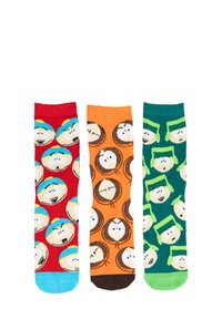 Tre paia di calzini: rossi con facce blu e gialle di personaggi, arancioni con cerchi e facce marroni, verdi con facce di personaggi e accenti.