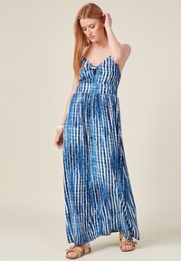 Maxikleid in Blau, mit gestreiftem Muster, verstellbaren Trägern, einem vorderen Schleifendetail und einer fließenden Silhouette mit leichtem Glanz.