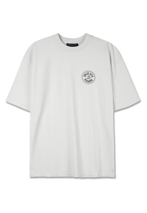 Hvit bomulls T-skjorte med kort erme, rund halsutringning og et sirkulært svart logo som leser "DOLCE VITA" på venstre brystområde.