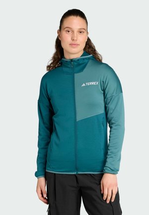 Teal fleece jacket with a zip front, hood, and contrasting panel; features a logo on the chest and cuffed sleeves, designed for outdoor use.