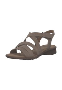 Beige leren sandalen met gekruiste banden en een verstelbare enkelband. Platte zool met een lichte kromming. Zachte textuur.