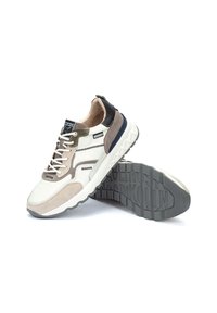 Zapatillas que combinan cuero blanco y gamuza gris, con una tapa de talón negra, suela texturizada gris y detalles de costura en contraste.