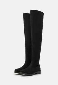 Black over-the-knee boots made of suede-like material with a flat sole, featuring a smooth texture and seamless design. No visible hardware.