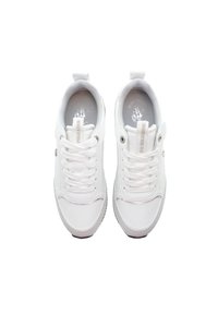 White sneakers with a smooth leather upper, round toe, lace-up front, and textured accents. Features a pull tab and subtle logo on the insole.