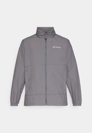 Szara, lekka kurtka wykonana z nylonu, z wysokim kołnierzem, pełnym zapięciem na zamek, elastycznymi mankietami oraz subtelnym logo na górnej lewej części klatki piersiowej.