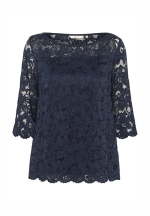 Marineblauw kanten top met driekwartmouwen, bloemendessin en een gegolfde zoom. Lichtgewicht stof met een gestructureerde afwerking.