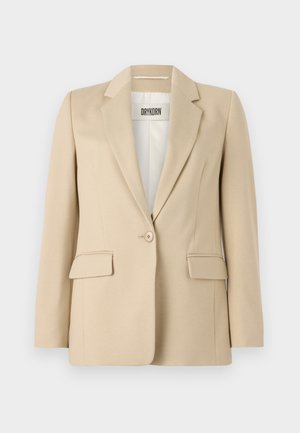 Beige blazer met geknipte revers, enkele knopen sluiting, twee voorzakken en een gladde textuur. Het label binnenin toont "DRYKORN."